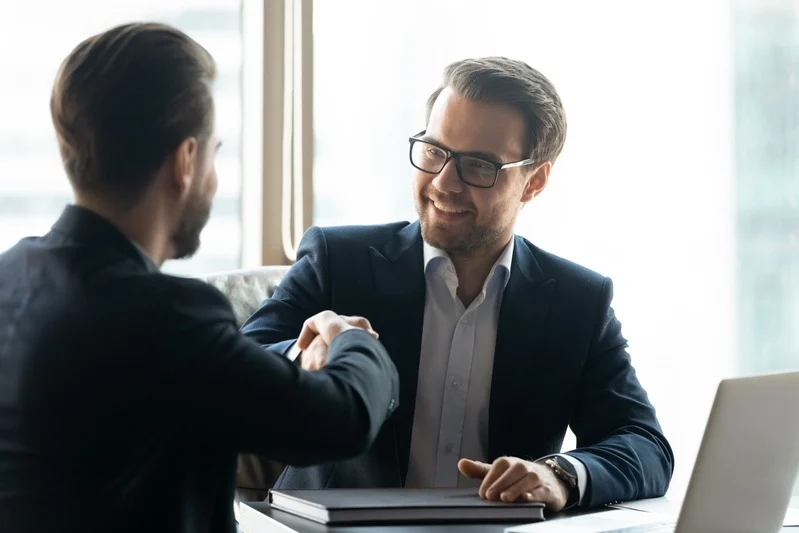Goal Staffing Solutions professionals discussing about payroll data on a tablet during a business meeting
