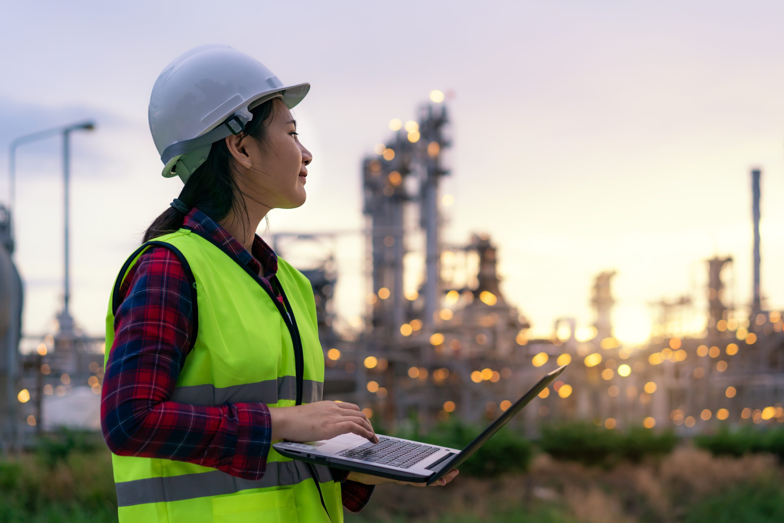 Asian,Woman,Petrochemical,Engineer,Working,At,Night,With,Laptop,Inside